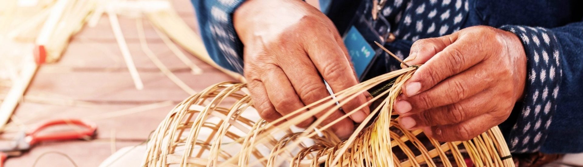 Hands weave bamboo baskets